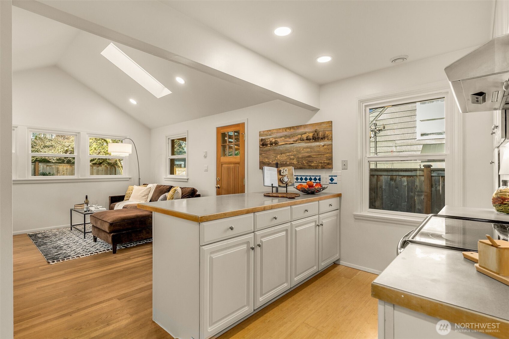5143 46th Avenue Northeast Seattle, WA 98105 - Photo 12 of 33 a kitchen with stainless steel appliances granite countertop a stove and a sink with cabinets