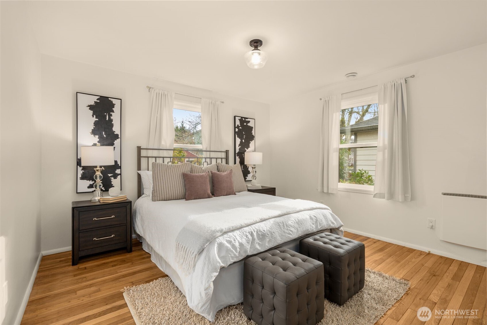 5143 46th Avenue Northeast Seattle, WA 98105 - Photo 17 of 33 a bedroom with a bed and wooden floor