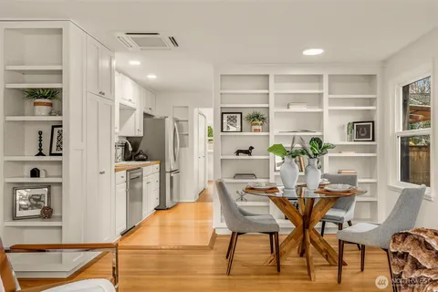 a kitchen with granite countertop white cabinets and stainless steel appliances