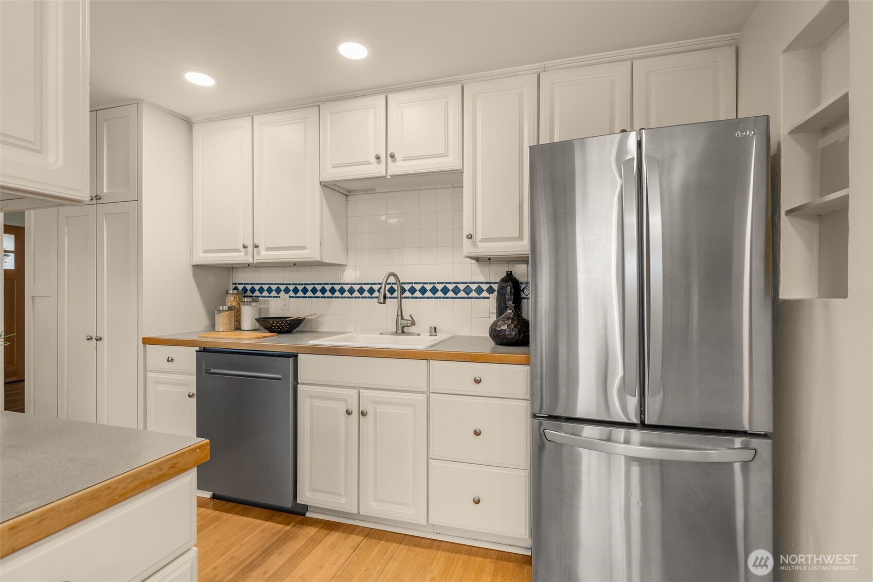 5143 46th Avenue Northeast Seattle, WA 98105 - Photo 10 of 33 a kitchen with stainless steel appliances a refrigerator and a stove