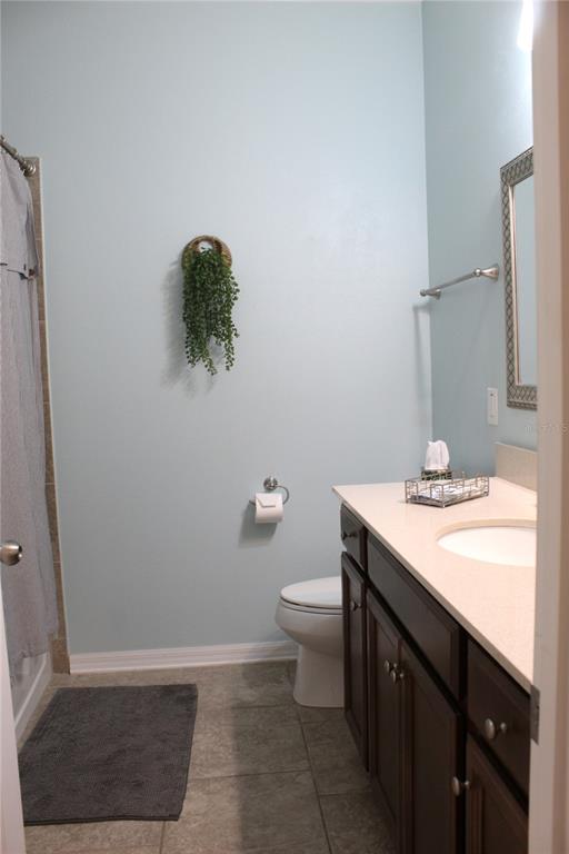 4110 Arlington Ridge Boulevard Leesburg, FL 34748 - Photo 15 of 33 a bathroom with a sink a toilet a mirror and vanity