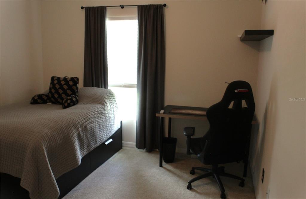 4110 Arlington Ridge Boulevard Leesburg, FL 34748 - Photo 18 of 33 a bedroom with a bed and a mirror