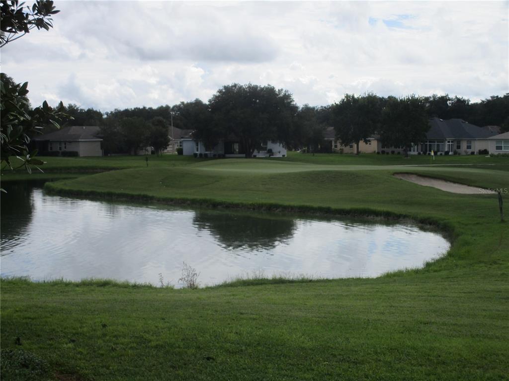 4110 Arlington Ridge Boulevard Leesburg, FL 34748 - Photo 27 of 33 a view of a golf course with a lake