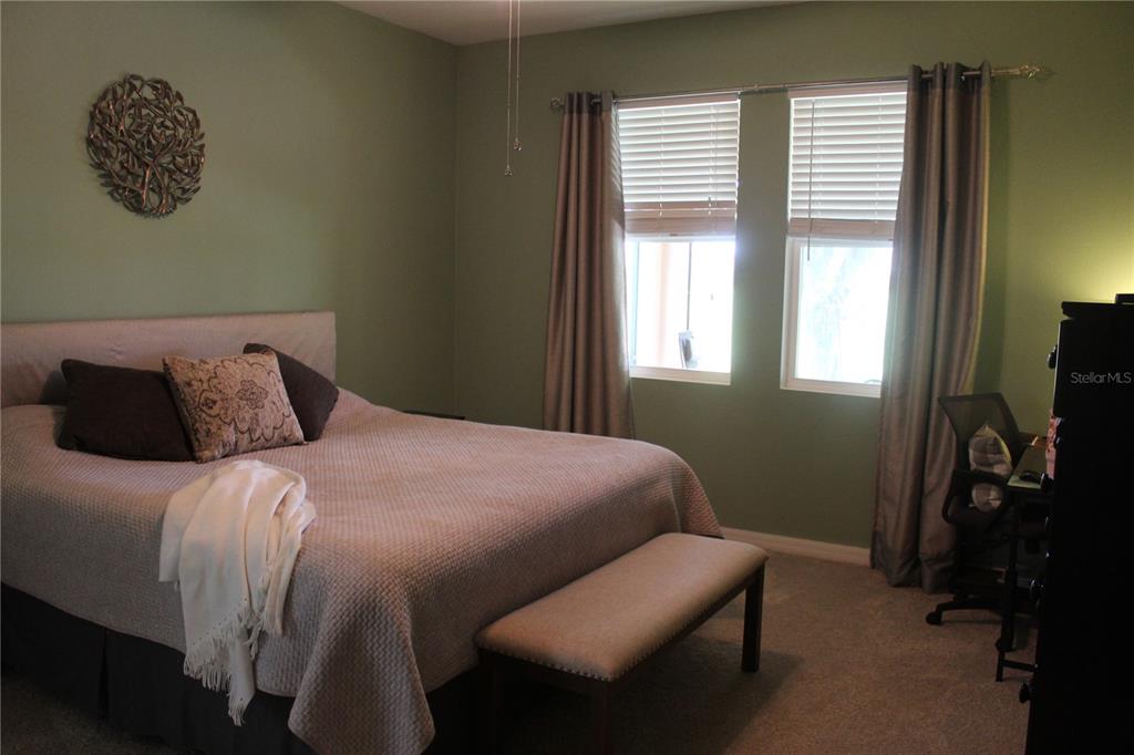4110 Arlington Ridge Boulevard Leesburg, FL 34748 - Photo 10 of 33 a bedroom with a bed dresser and a window