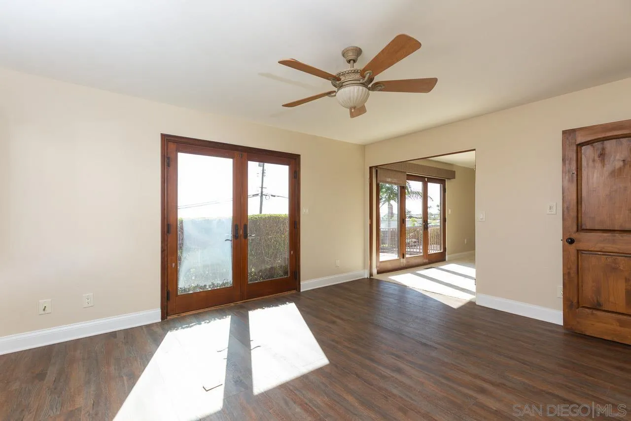 6724 Dwane Avenue San Diego, CA 92120 - Photo 22 of 38 a view of an empty room with window and wooden floor