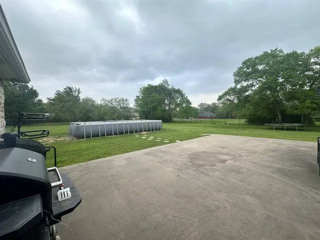 a view of a field of grass and trees