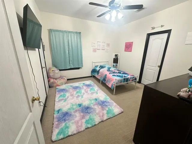 a bedroom with furniture and a window