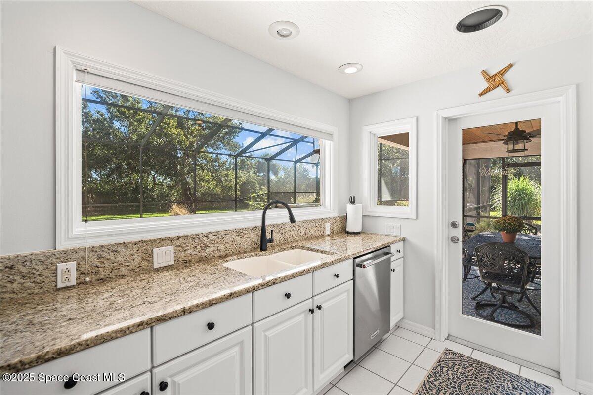 3651 Big Pine Road Melbourne, FL 32934 - Photo 12 of 32 a kitchen with granite countertop a sink and a window