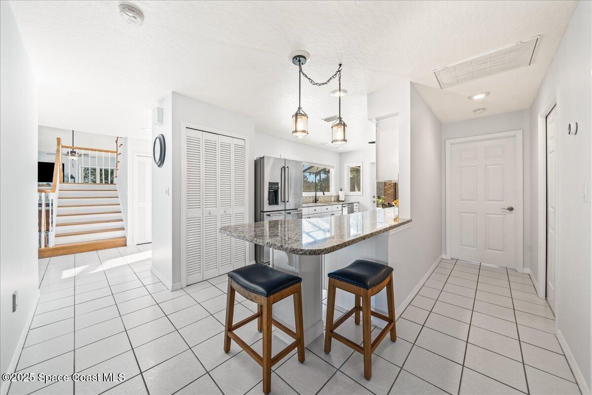 3651 Big Pine Road Melbourne, FL 32934 - Photo 14 of 32 a kitchen with stainless steel appliances a sink and cabinets