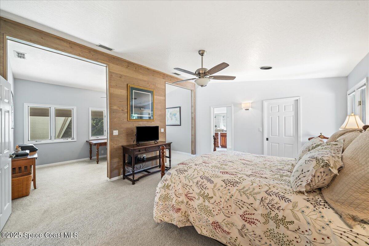 3651 Big Pine Road Melbourne, FL 32934 - Photo 17 of 32 a bedroom with a bed a desk and chair