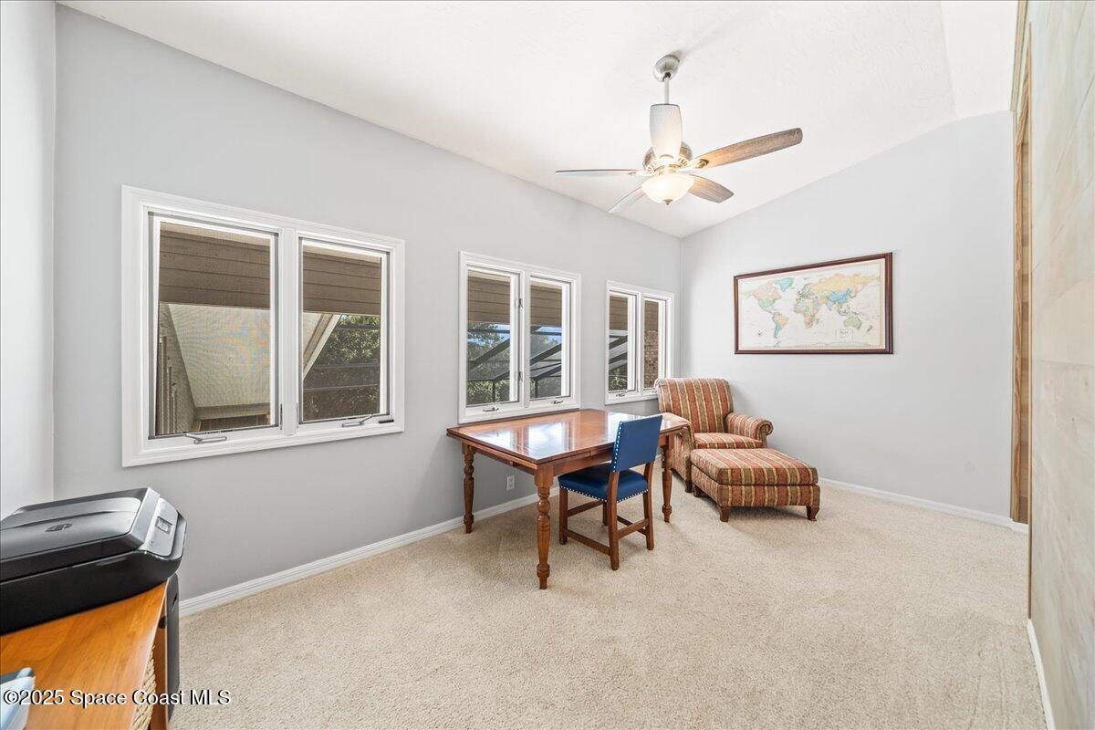3651 Big Pine Road Melbourne, FL 32934 - Photo 19 of 32 a living room with furniture two window and a table