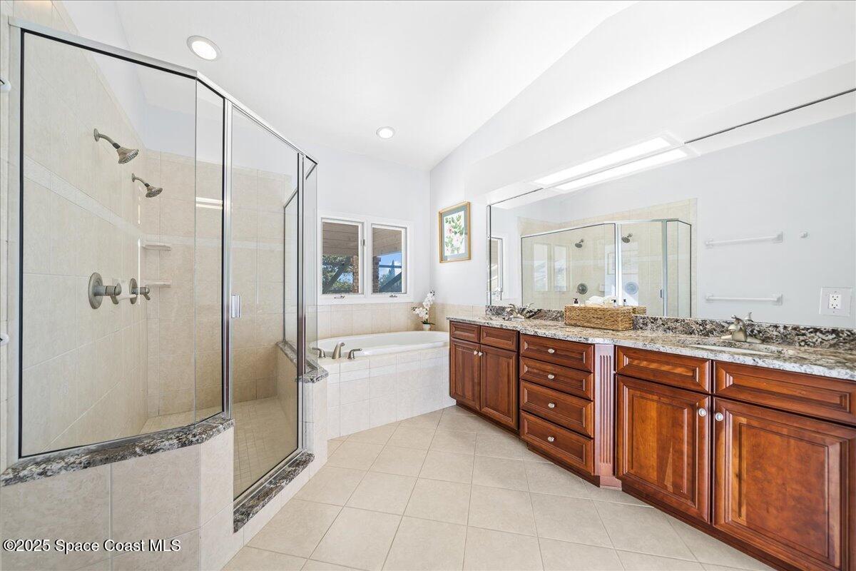 3651 Big Pine Road Melbourne, FL 32934 - Photo 20 of 32 a large bathroom with a granite countertop tub sink shower and mirror
