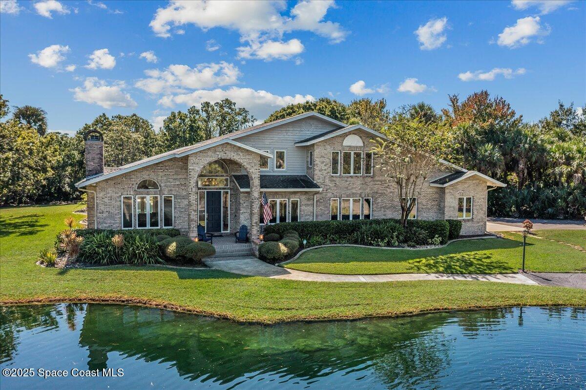 3651 Big Pine Road Melbourne, FL 32934 - Photo 2 of 32 a front view of a house with garden and porch