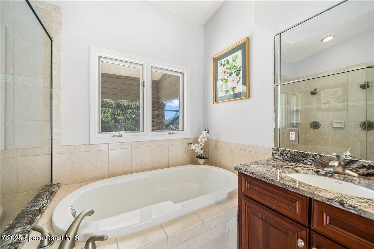 3651 Big Pine Road Melbourne, FL 32934 - Photo 21 of 32 a bathroom with a granite countertop tub sink and mirror