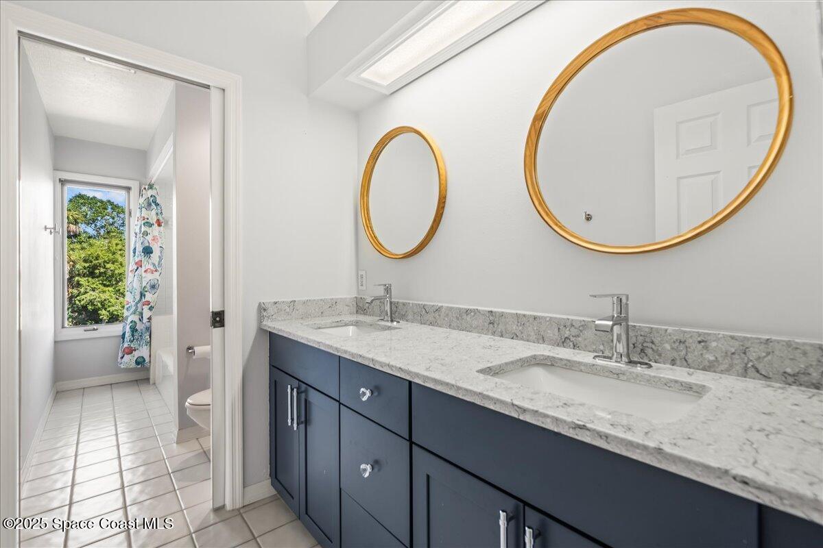 3651 Big Pine Road Melbourne, FL 32934 - Photo 23 of 32 a bathroom with a granite countertop double vanity sink and a mirror