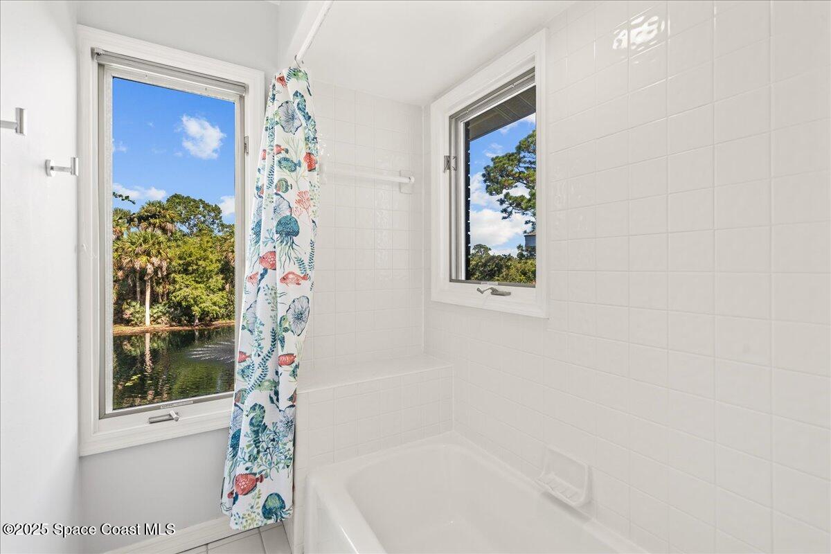3651 Big Pine Road Melbourne, FL 32934 - Photo 24 of 32 a bathroom with a bathtub and shower
