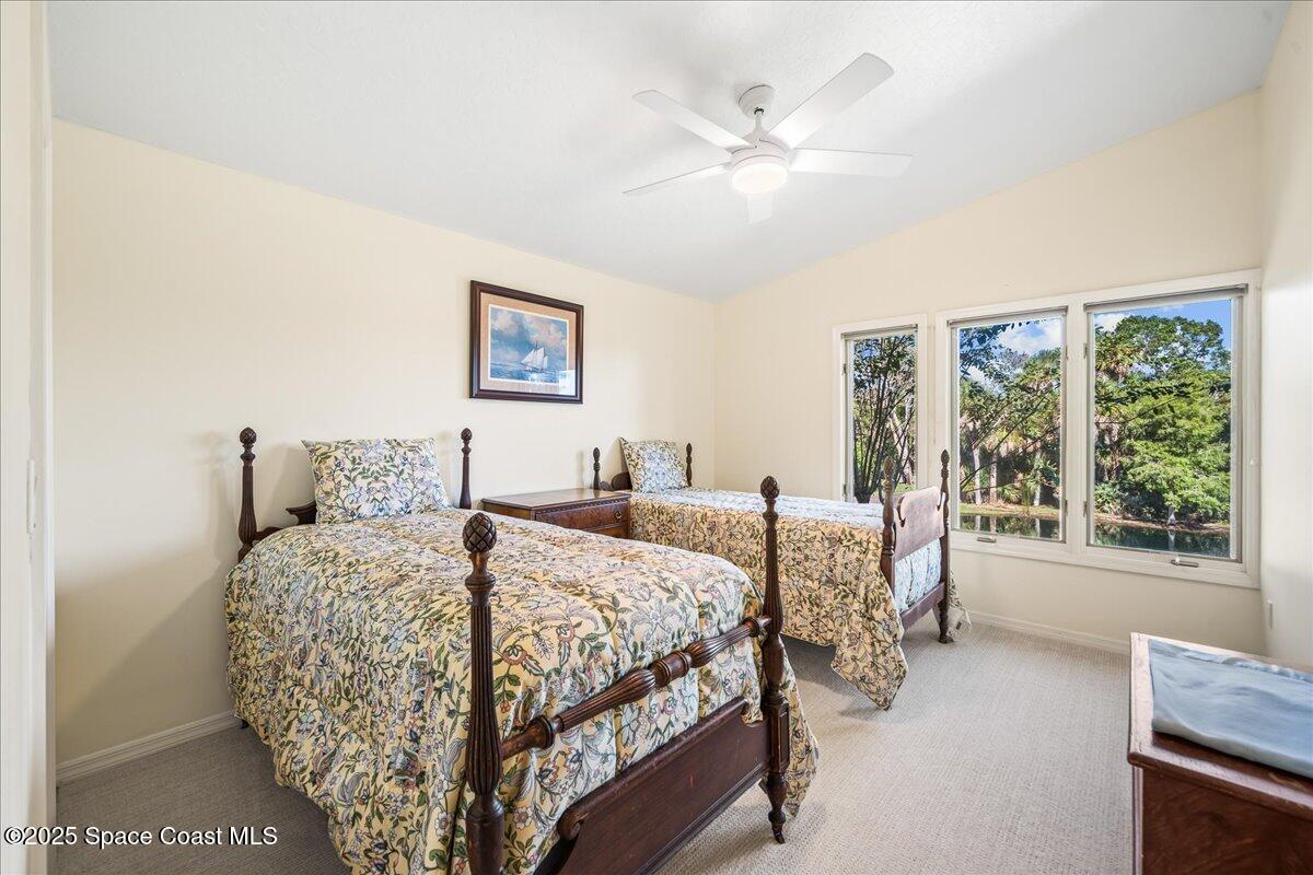 3651 Big Pine Road Melbourne, FL 32934 - Photo 25 of 32 a bedroom with a large bed and a large window