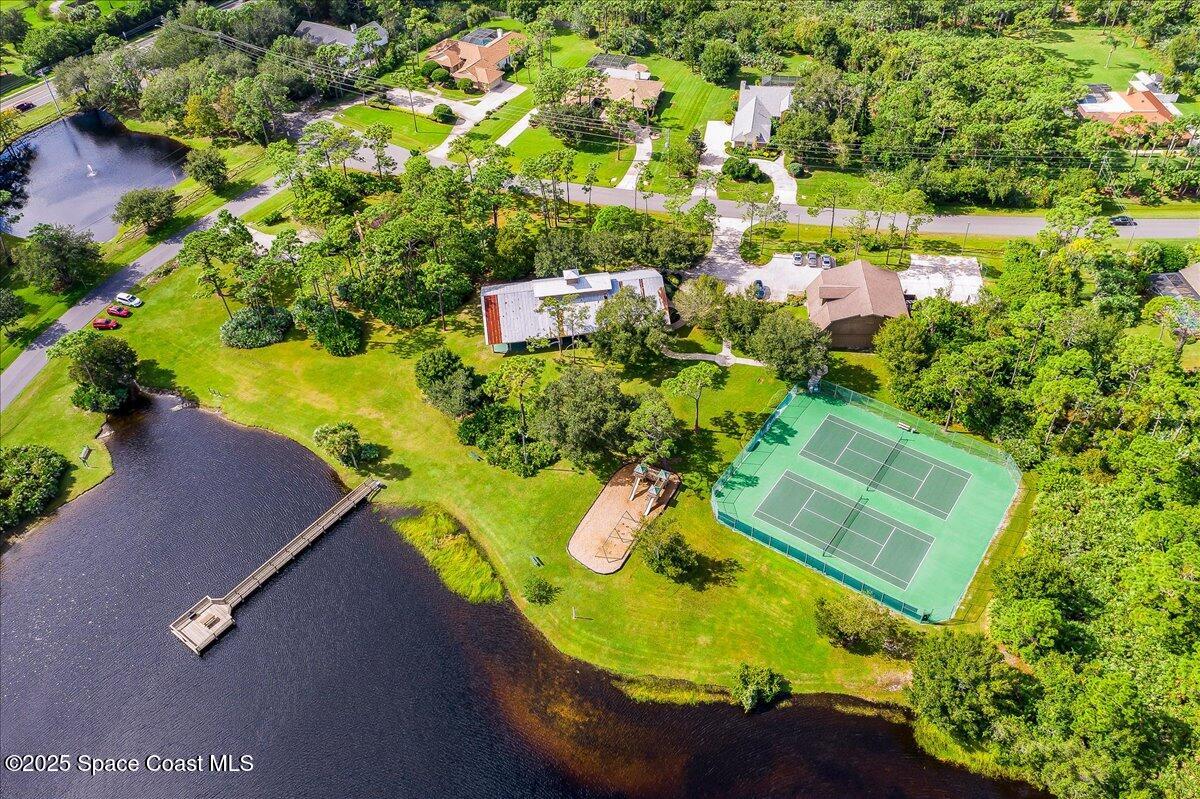 3651 Big Pine Road Melbourne, FL 32934 - Photo 27 of 32 an aerial view of a house with a yard and swimming pool