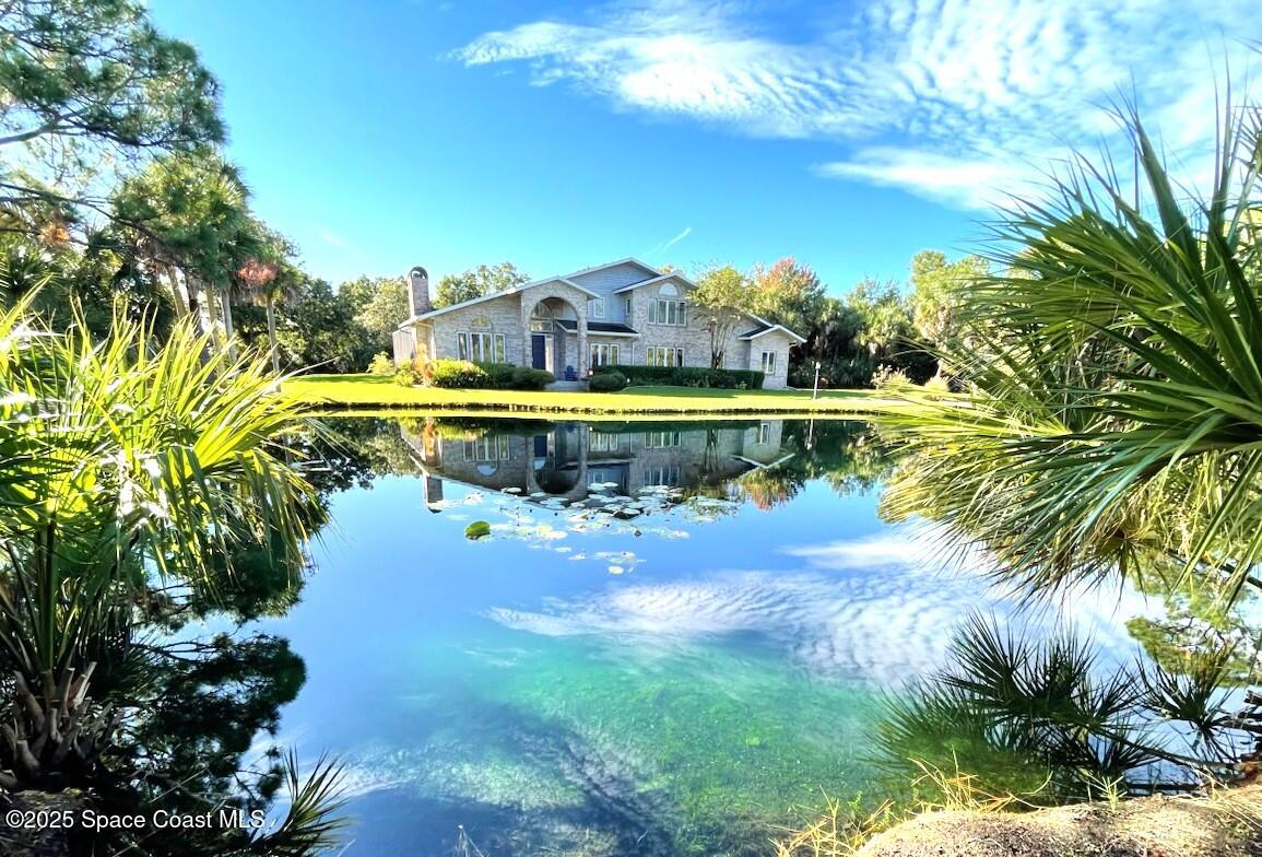3651 Big Pine Road Melbourne, FL 32934 - Photo 31 of 32 a view of a swimming pool with a yard