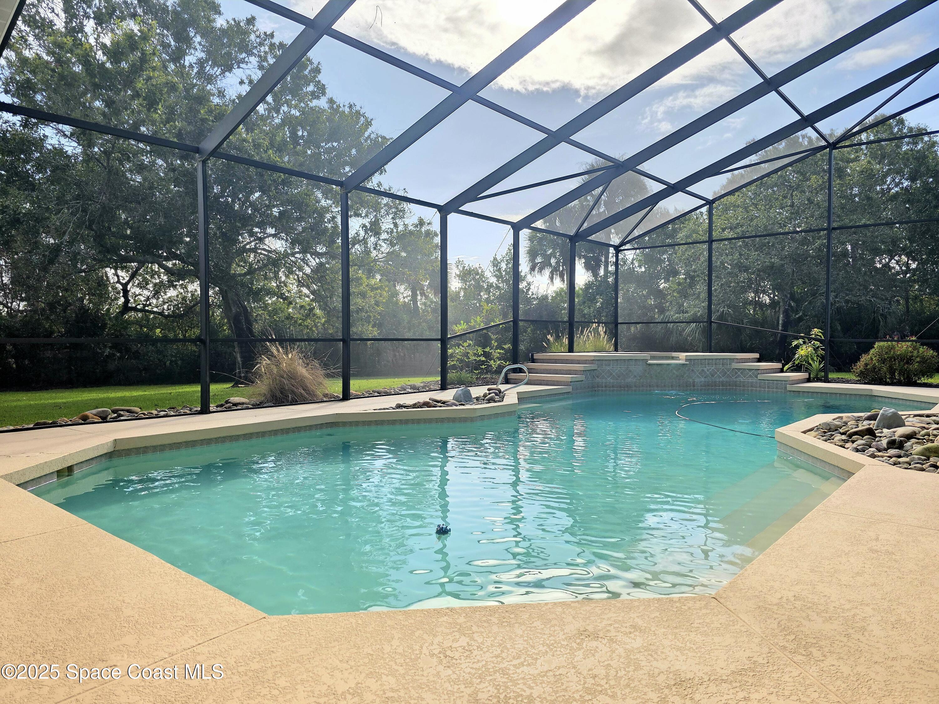 3651 Big Pine Road Melbourne, FL 32934 - Photo 4 of 32 a view of a swimming pool with a patio