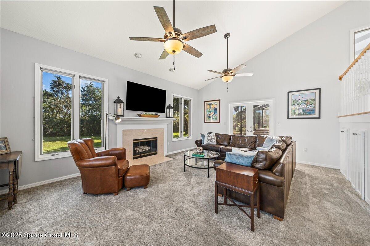 3651 Big Pine Road Melbourne, FL 32934 - Photo 6 of 32 a living room with furniture a fireplace and a flat screen tv