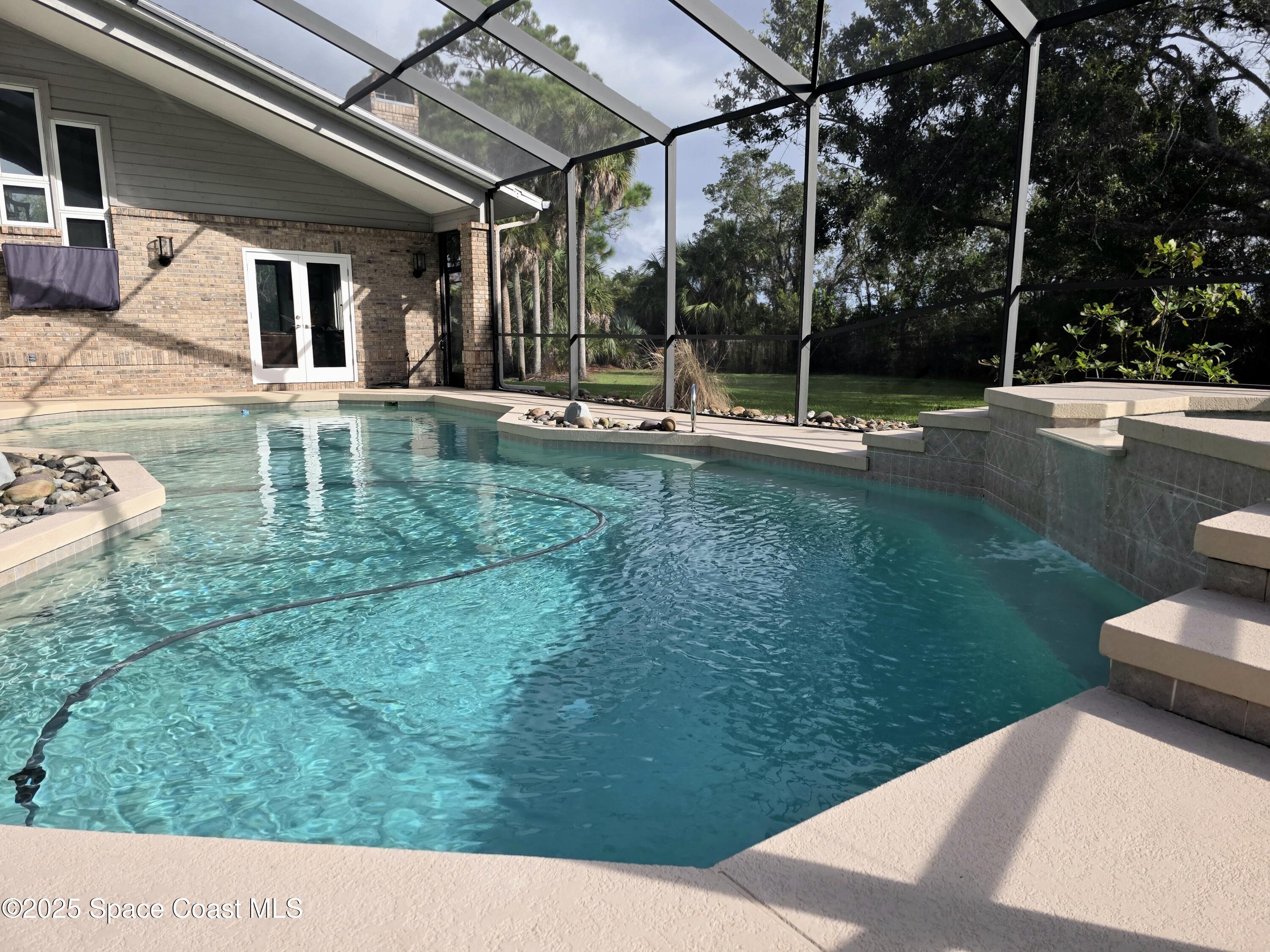 3651 Big Pine Road Melbourne, FL 32934 - Photo 8 of 32 a view of a swimming pool with a patio