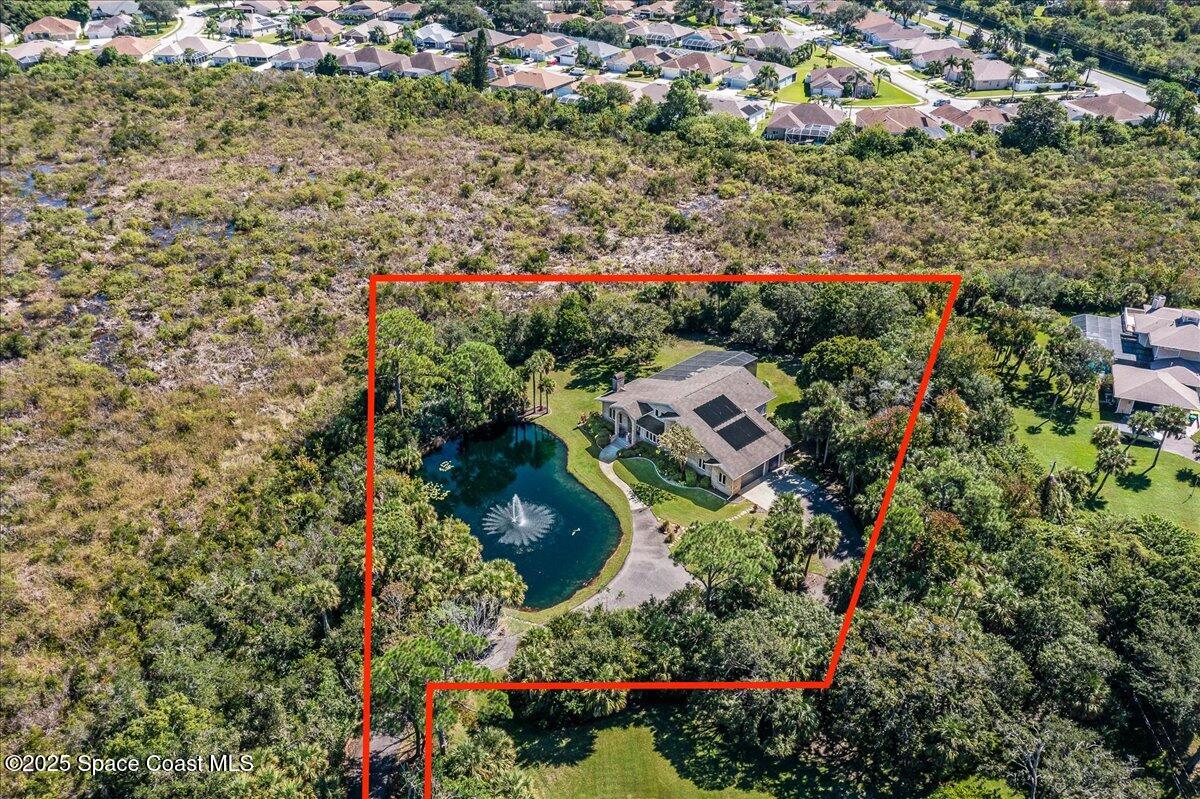 3651 Big Pine Road Melbourne, FL 32934 - Photo 9 of 32 an aerial view of residential house with outdoor space and trees all around