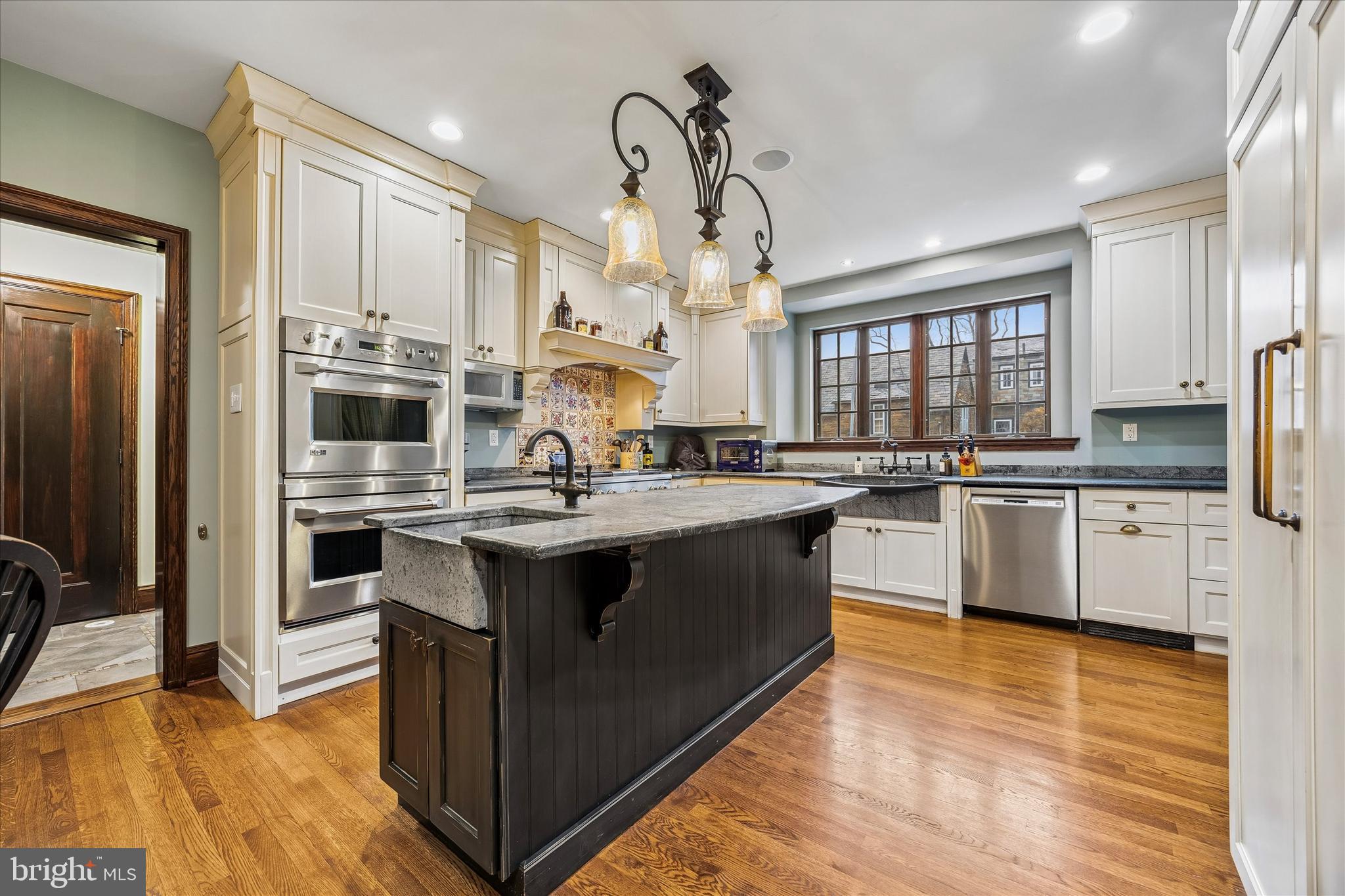 239 Winding Way Merion Station, PA 19066 - Photo 13 of 48 a kitchen with stainless steel appliances granite countertop a stove and cabinets