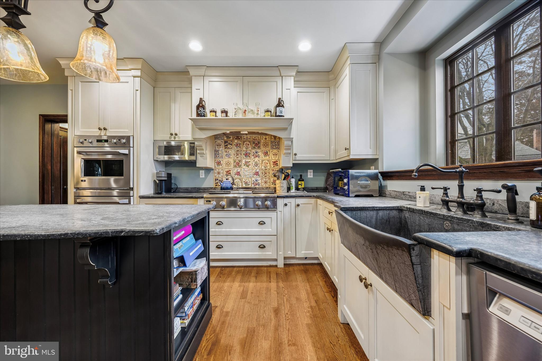 239 Winding Way Merion Station, PA 19066 - Photo 14 of 48 a kitchen with granite countertop kitchen island stainless steel appliances a sink stove and cabinets