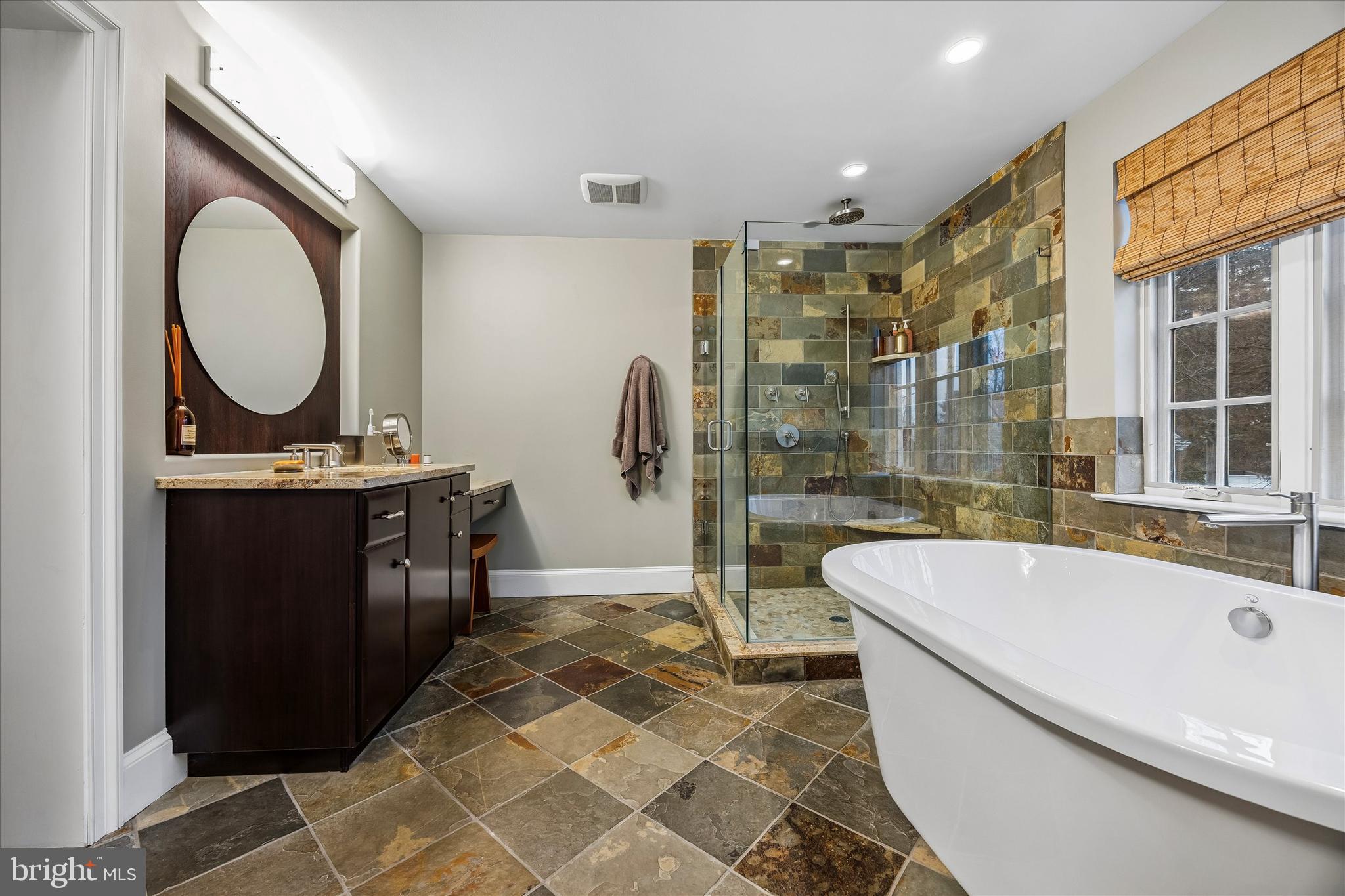 239 Winding Way Merion Station, PA 19066 - Photo 28 of 48 a bathroom with a tub a sink and a large mirror