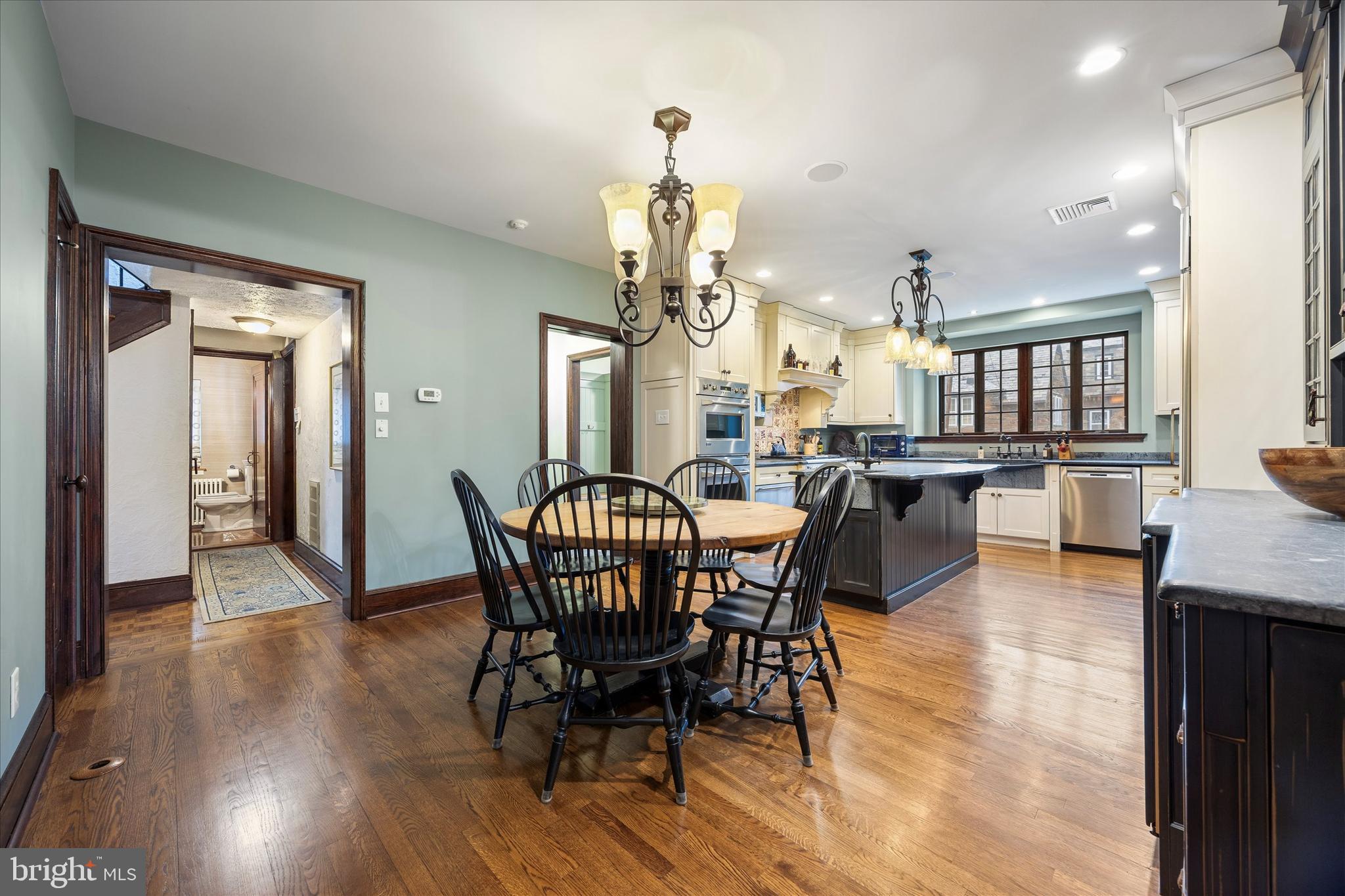 239 Winding Way Merion Station, PA 19066 - Photo 10 of 48 a dining room with wooden floor a chandelier a wooden table and chairs