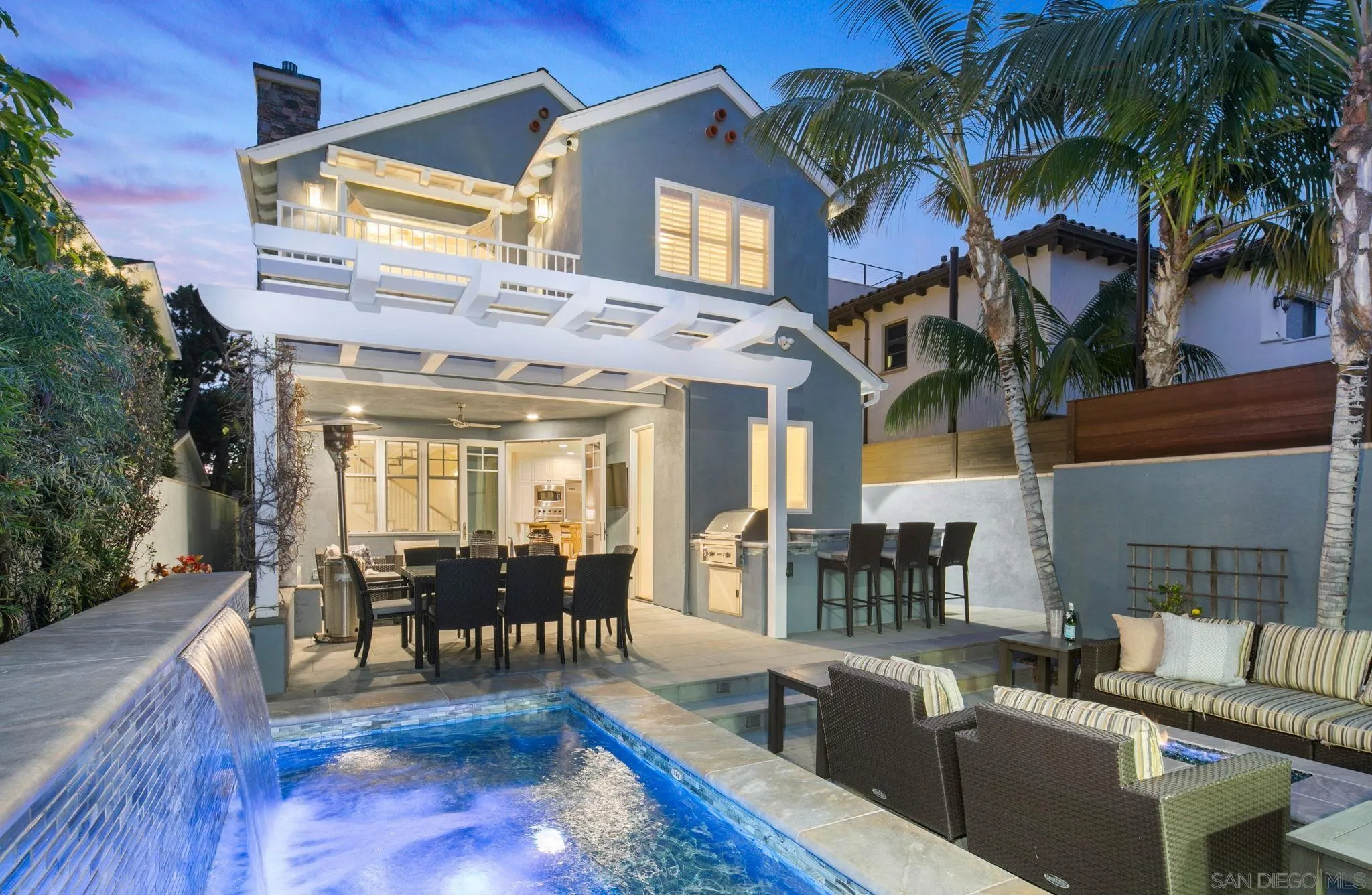a view of a patio with couches table and chairs and potted plants