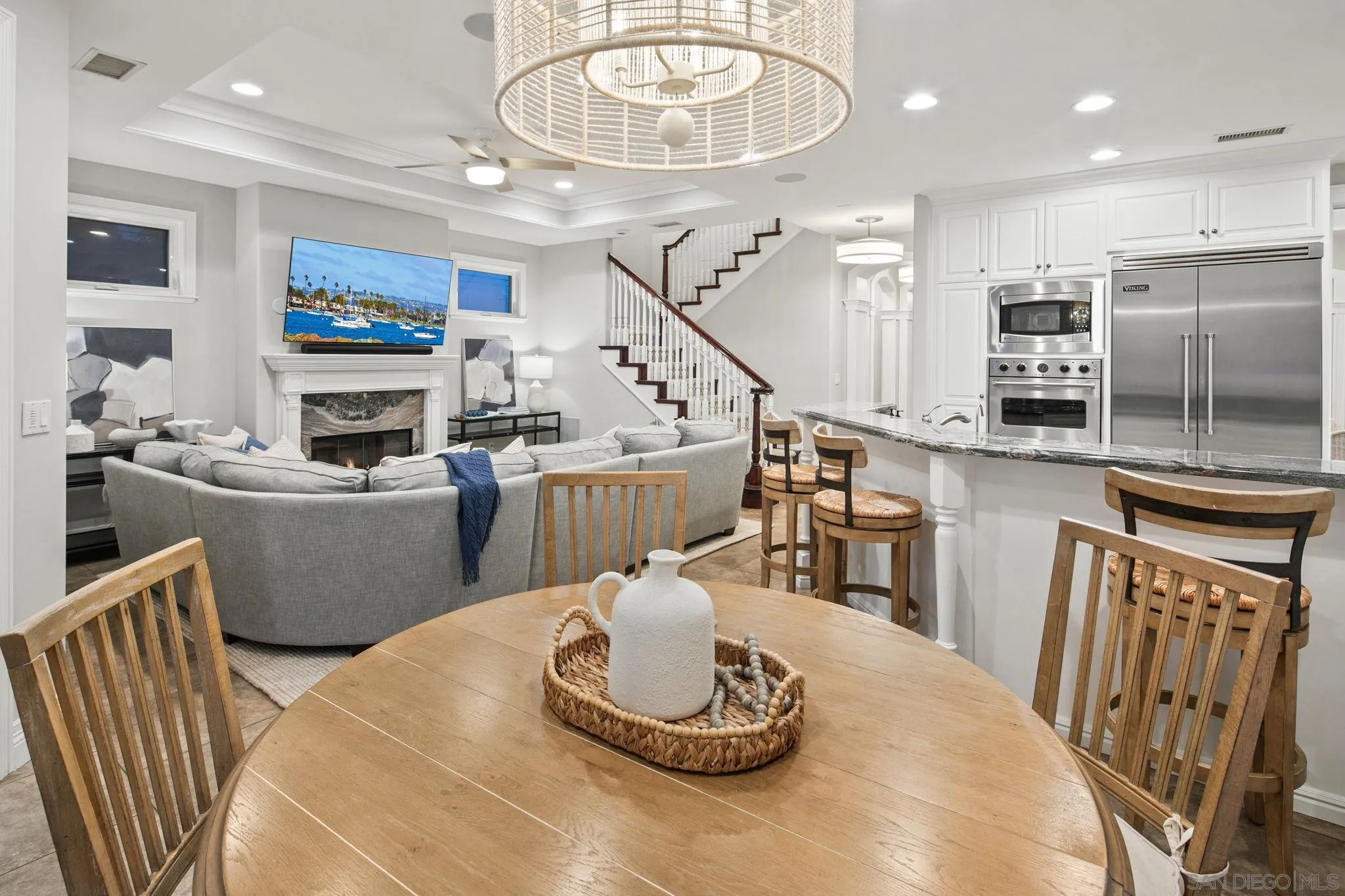861 B Avenue Coronado, CA 92118 - Photo 14 of 45 a living room with furniture kitchen view and a chandelier