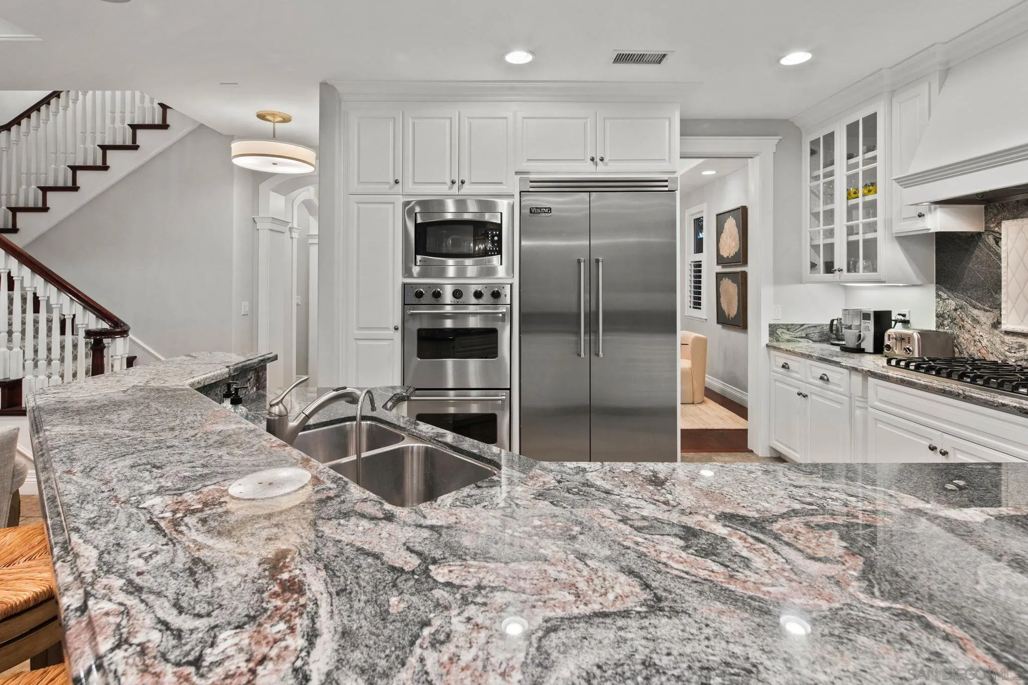 861 B Avenue Coronado, CA 92118 - Photo 19 of 45 a kitchen with stainless steel appliances kitchen island granite countertop a refrigerator and a sink