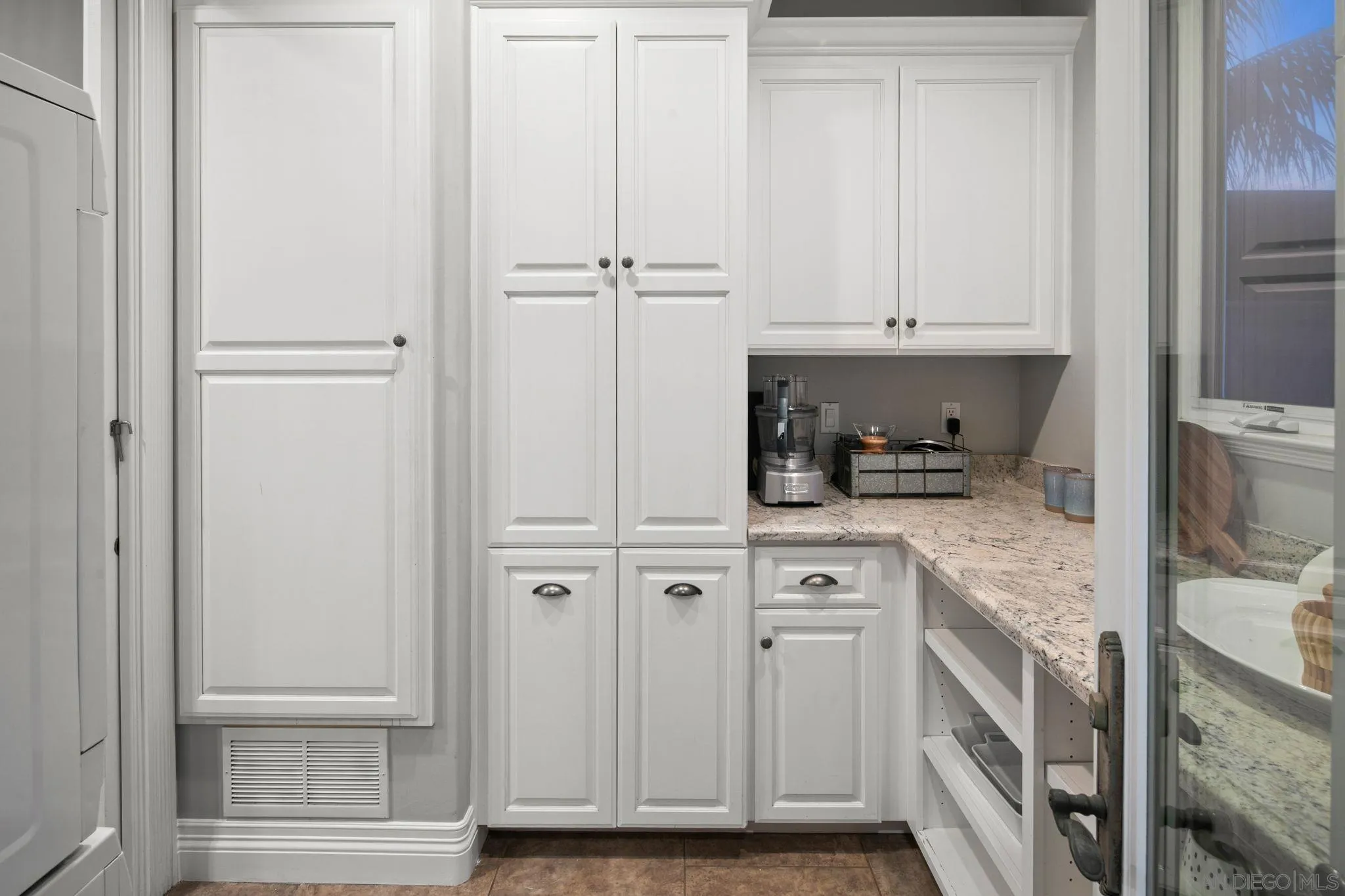 861 B Avenue Coronado, CA 92118 - Photo 27 of 45 a kitchen with white cabinets and white appliances