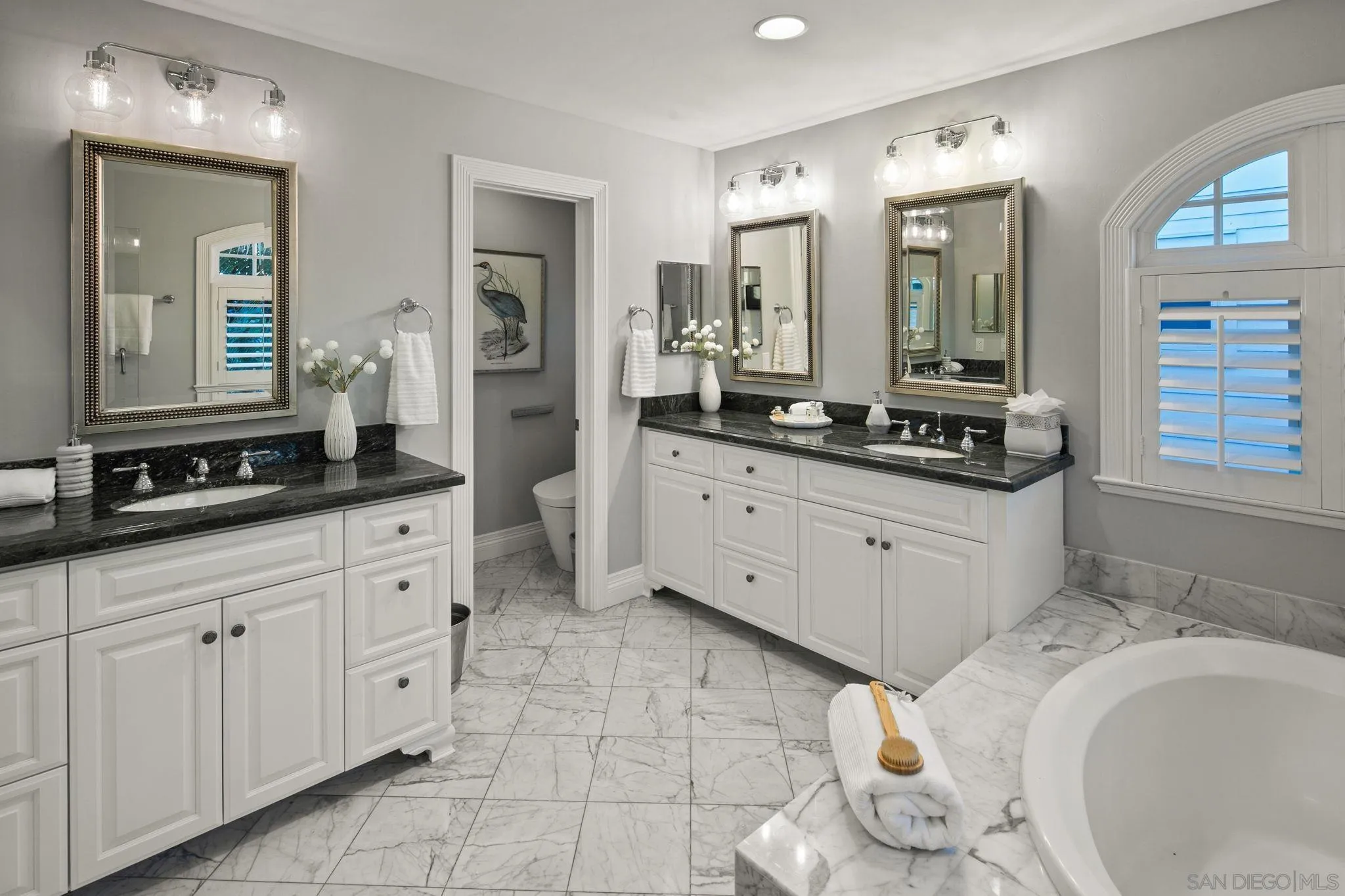 861 B Avenue Coronado, CA 92118 - Photo 32 of 45 a spacious bathroom with a granite countertop sink mirror and vanity