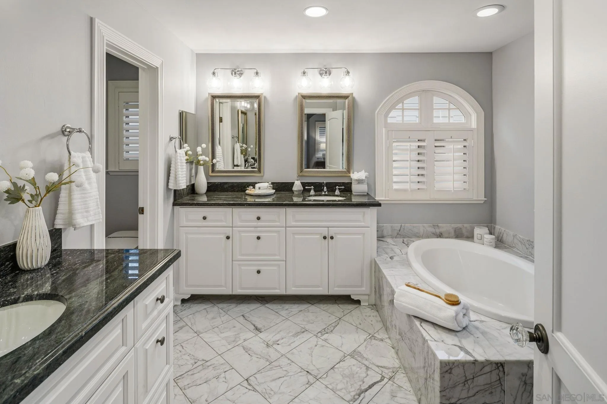 861 B Avenue Coronado, CA 92118 - Photo 33 of 45 a spacious bathroom with a granite countertop sink mirror and a bathtub