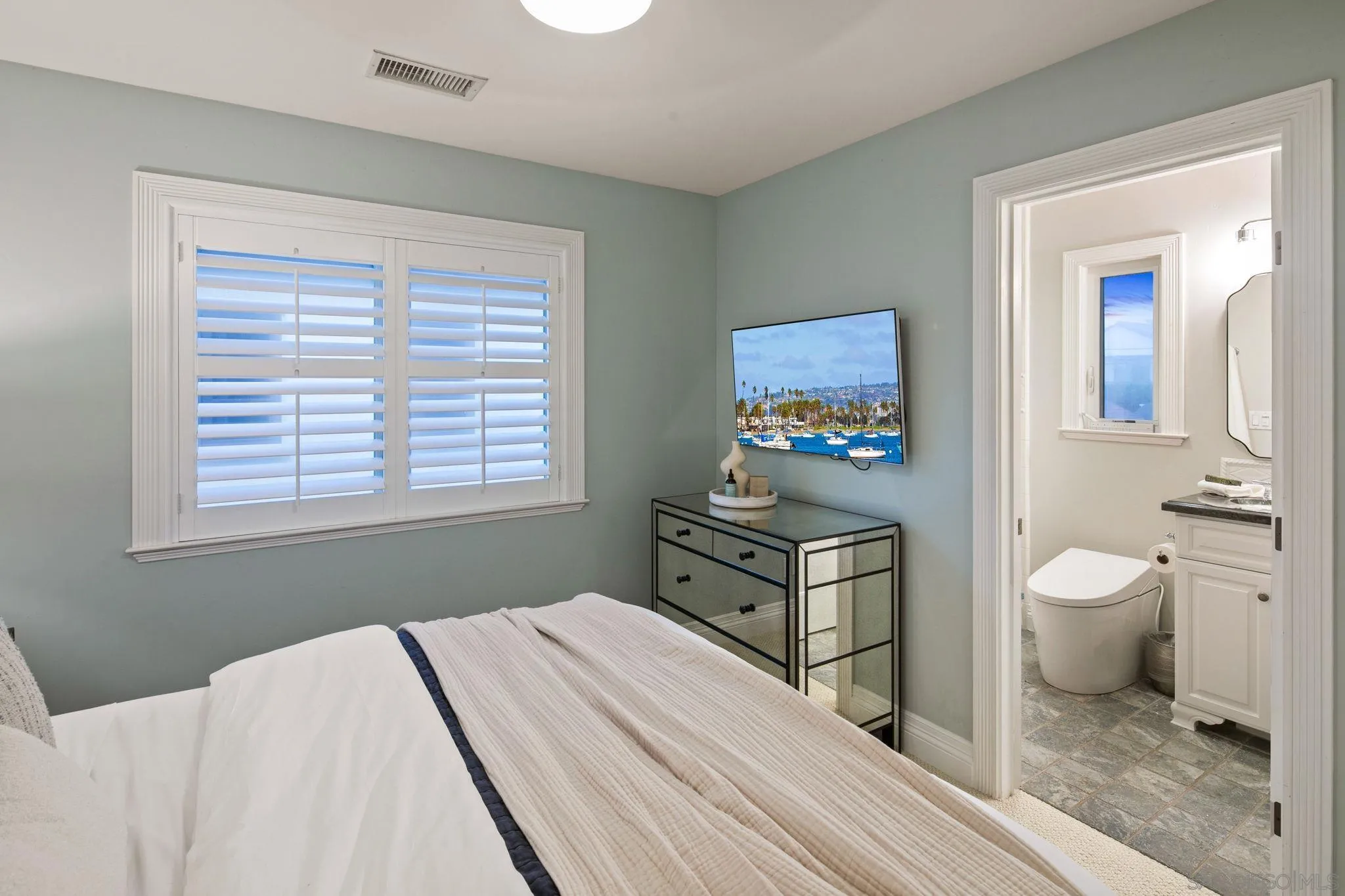 861 B Avenue Coronado, CA 92118 - Photo 37 of 45 a bedroom with a bed and a table in it