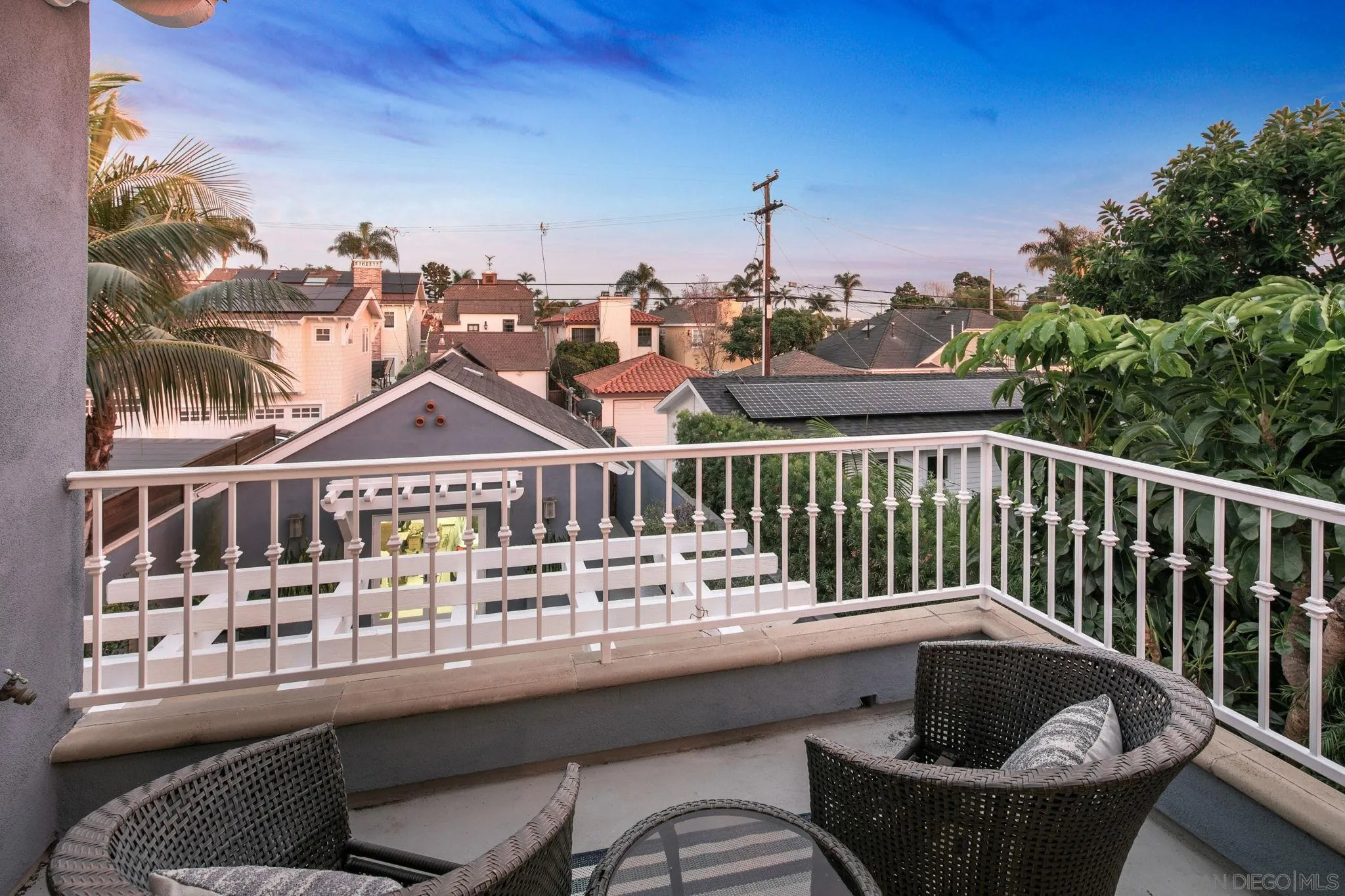 861 B Avenue Coronado, CA 92118 - Photo 42 of 45 a view of a brick house with a chairs and floor to ceiling window