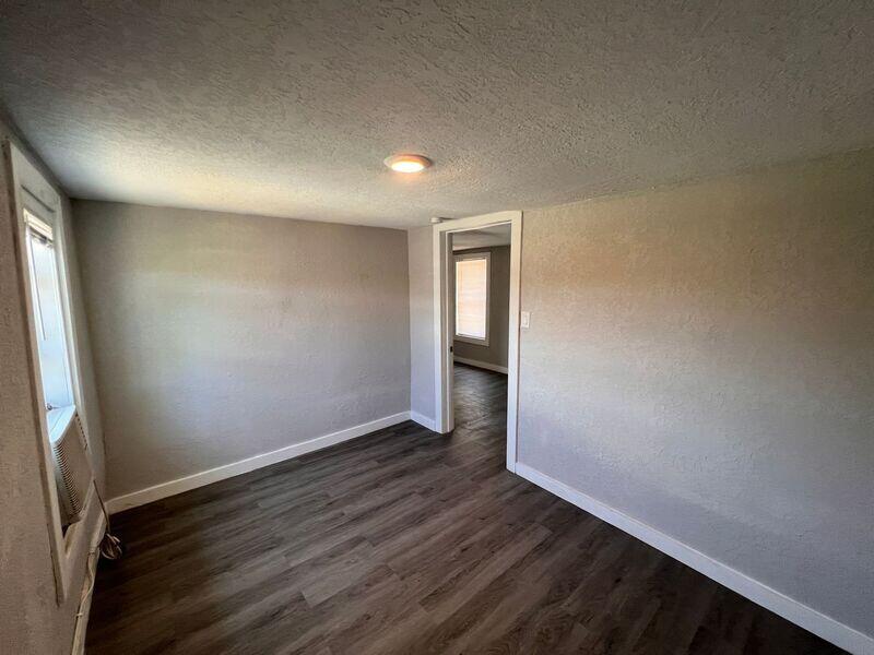 718 West 7th Street, Unit 2 Riviera Beach, FL 33404 - Photo 18 of 21 an empty room with wooden floor and windows