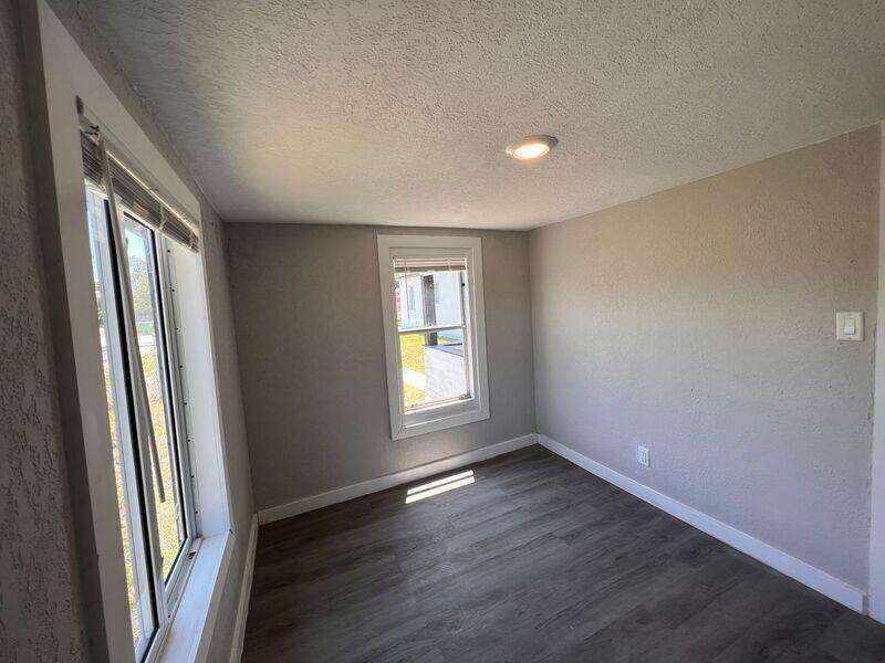 718 West 7th Street, Unit 2 Riviera Beach, FL 33404 - Photo 20 of 21 an empty room with wooden floor and window