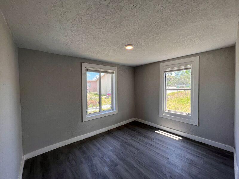 718 West 7th Street, Unit 2 Riviera Beach, FL 33404 - Photo 21 of 21 a view of an empty room with wooden floor and a window