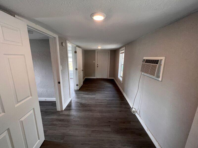 718 West 7th Street, Unit 2 Riviera Beach, FL 33404 - Photo 8 of 21 a view of a hallway with wooden floor and staircase