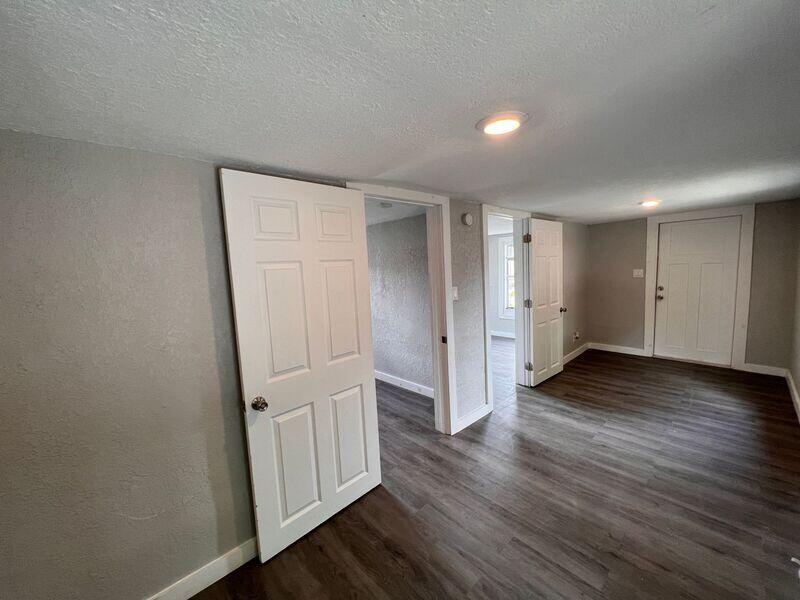 718 West 7th Street, Unit 2 Riviera Beach, FL 33404 - Photo 9 of 21 an empty room with wooden floor and closet