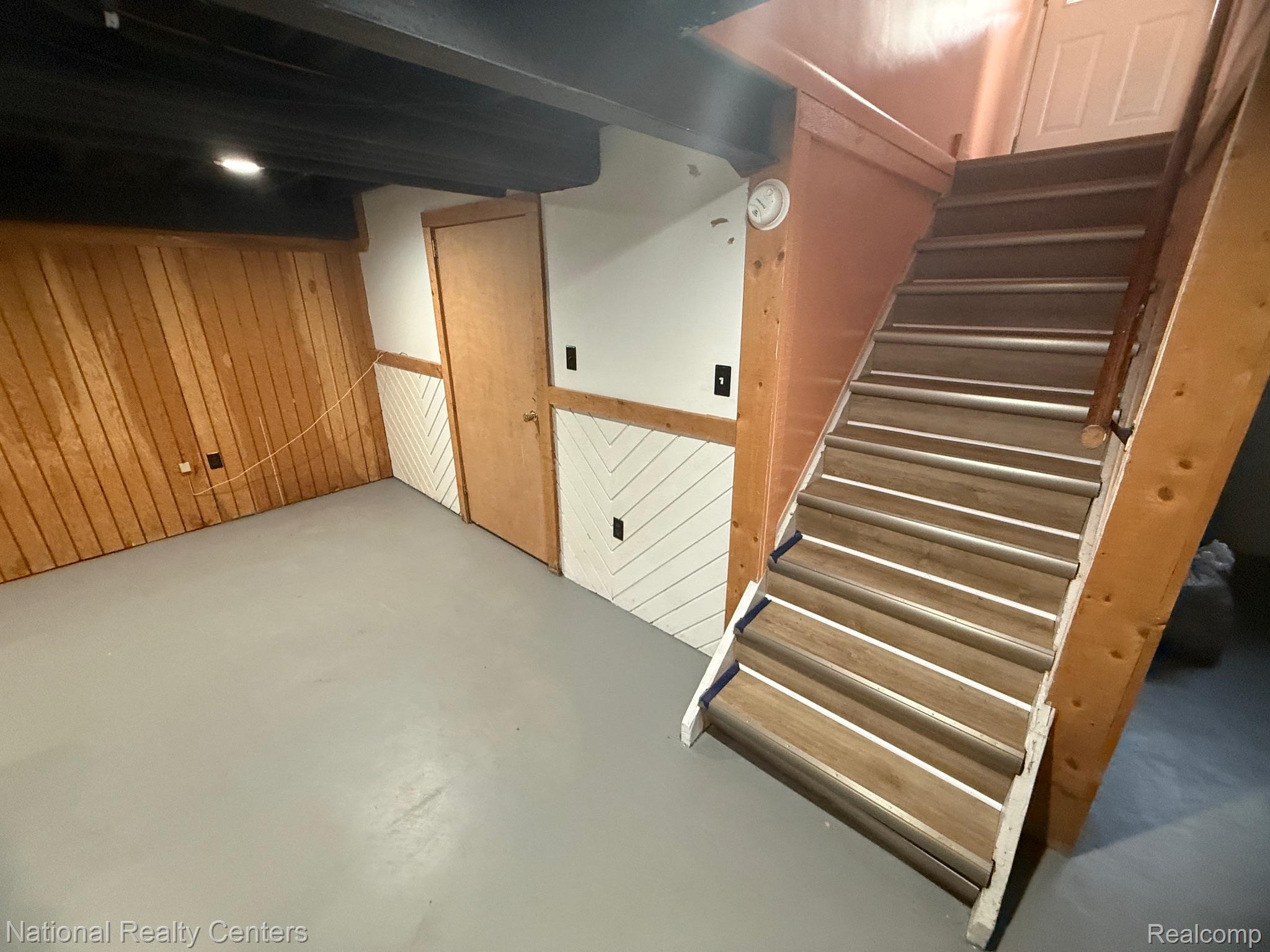 9920 Farmington Road Livonia, MI 48150 - Photo 18 of 20 Wood paneling accents a finished wall