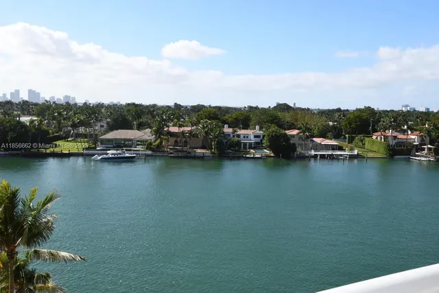 a view of a lake with boats and trees in the background