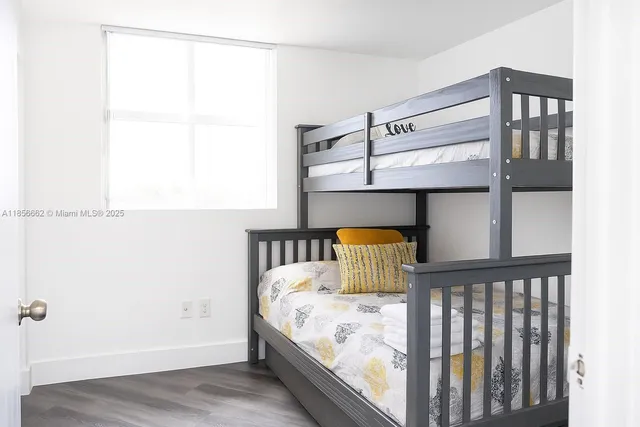 a bed sitting in a bedroom next to a window