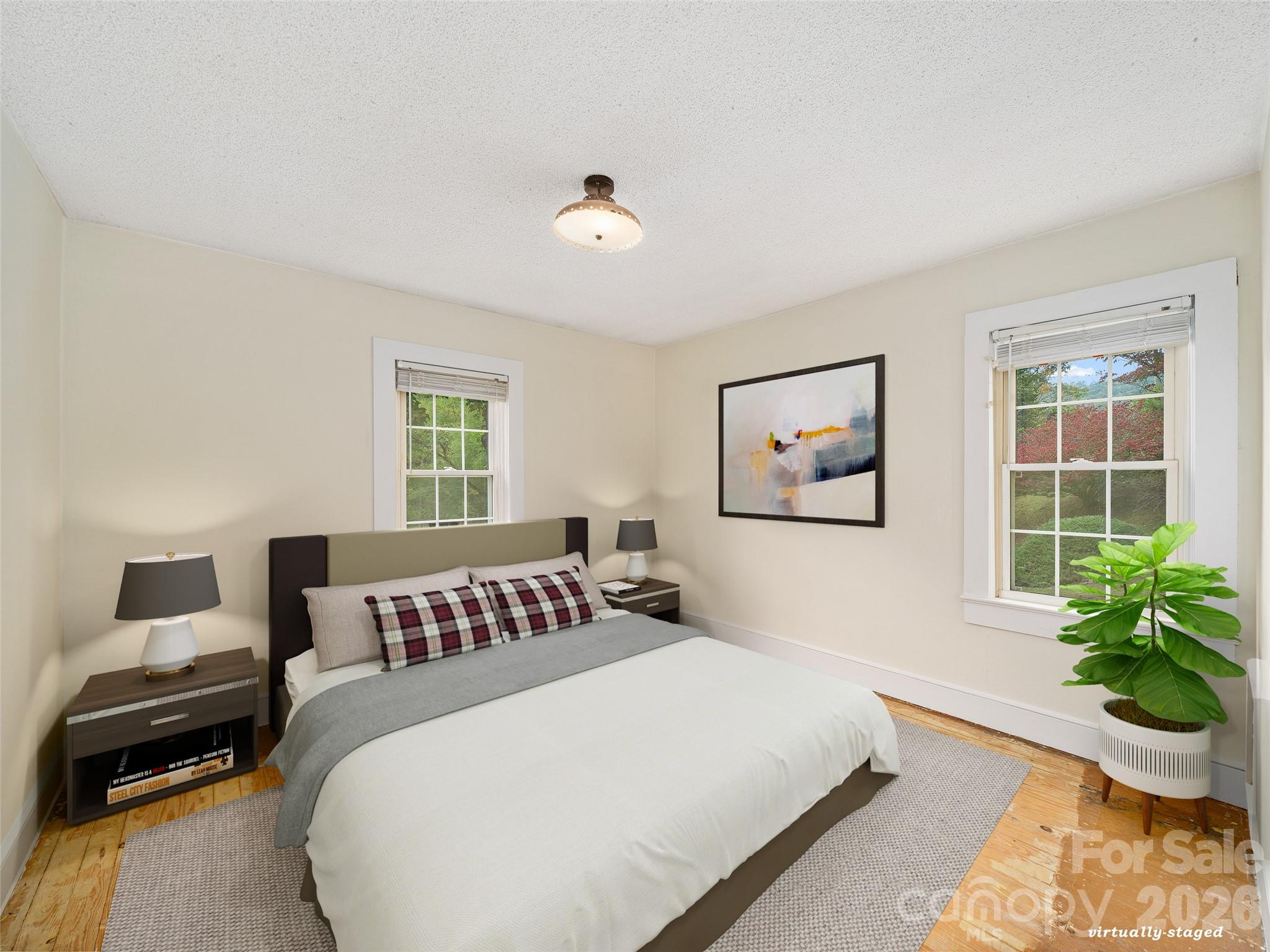 338 Sweet Creek Road Bakersville, NC 28705 - Photo 13 of 21 a bedroom with a large bed and a window