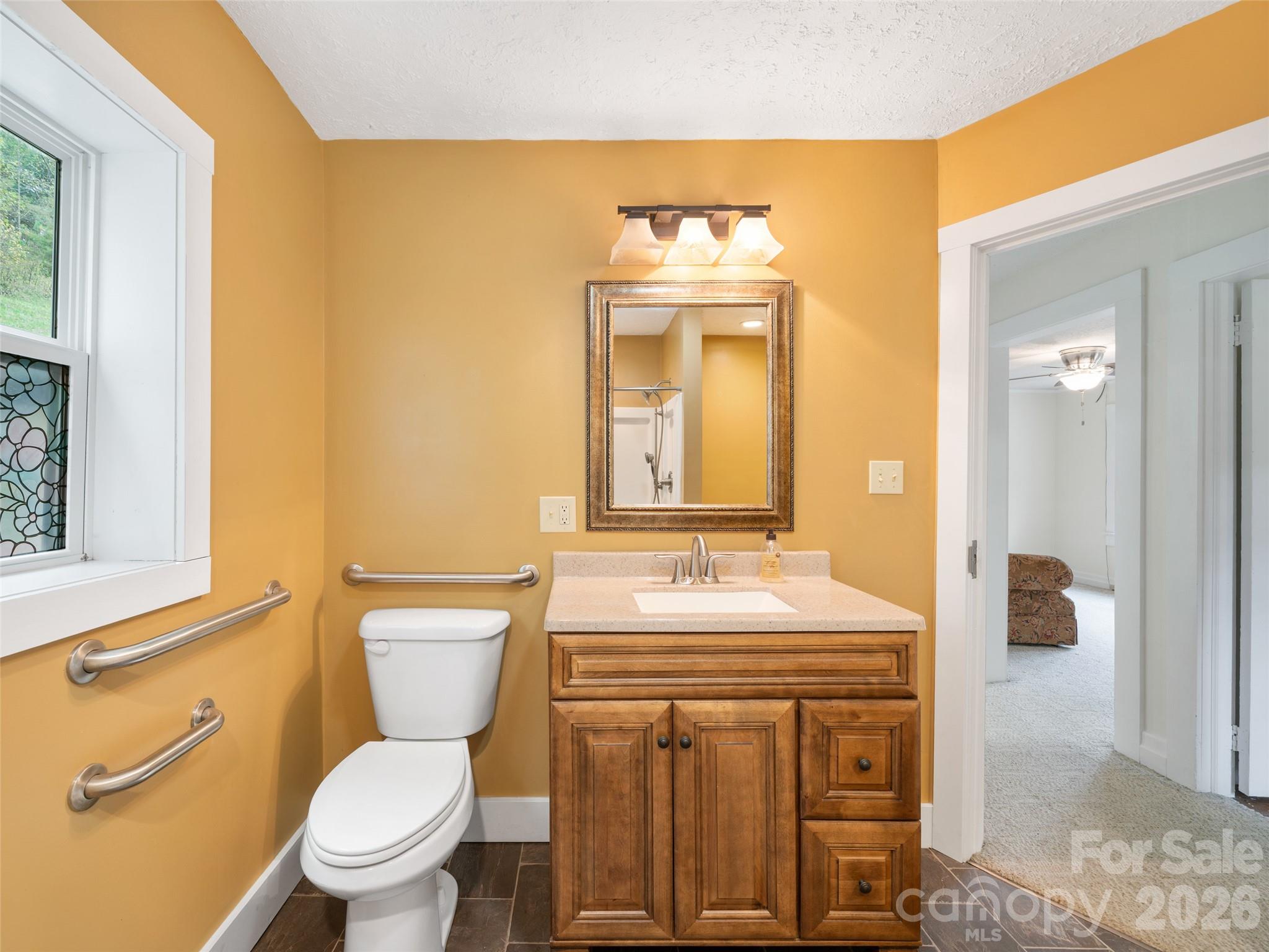338 Sweet Creek Road Bakersville, NC 28705 - Photo 16 of 21 a bathroom with a toilet a sink and a mirror