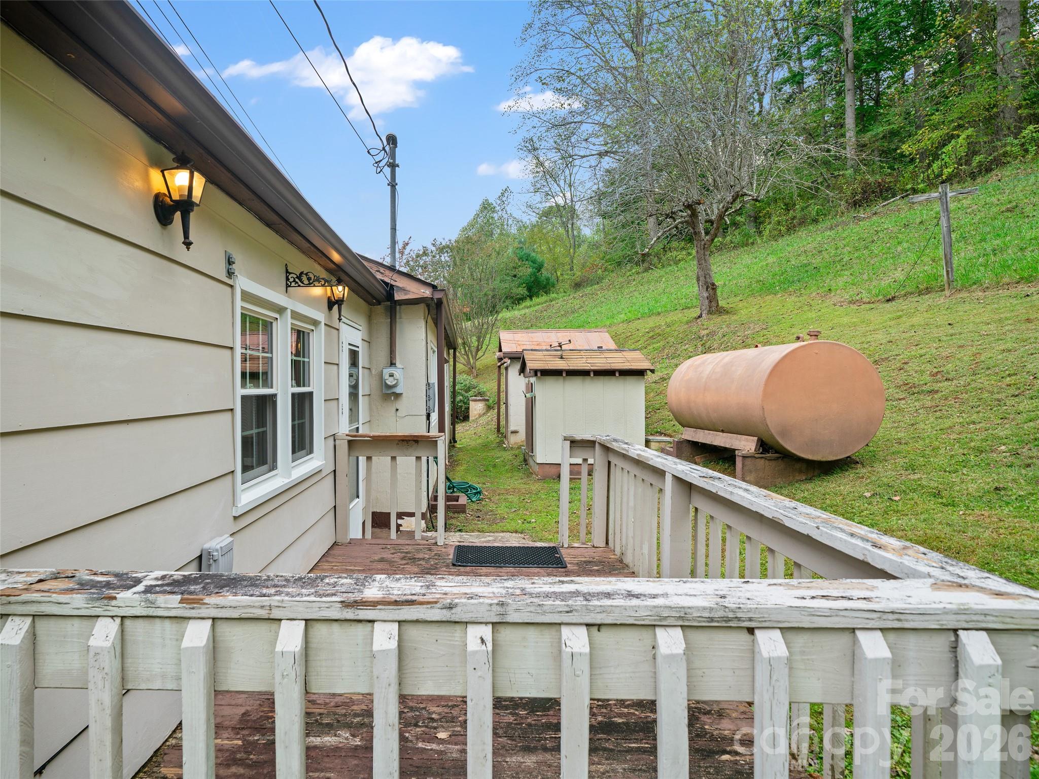 338 Sweet Creek Road Bakersville, NC 28705 - Photo 18 of 21 a view of house with backyard and iron fence